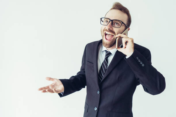 istock Excited business man talking on smartphone loud and gesturing 1067315282