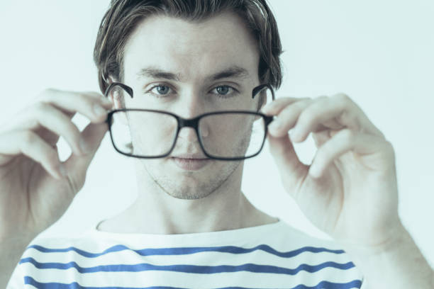 istock Confident purposeful man holding glasses and looking through it 1067315364