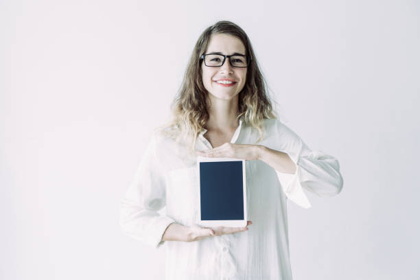 istock Smiling optimistic student girl showing tablet screen 1067315388