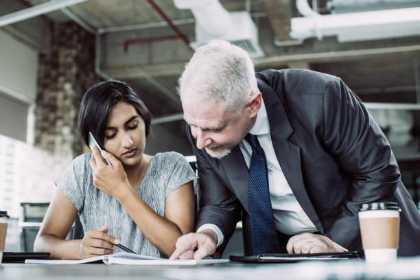 istock Focused business leader supervising managers work 1067319478