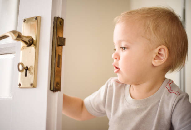 istock Cute baby playing with a door 1067322654