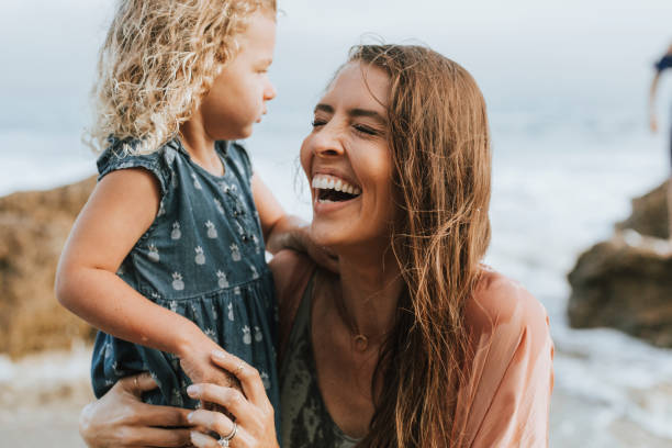 istock Mom with young daughter at a beach 1067323250