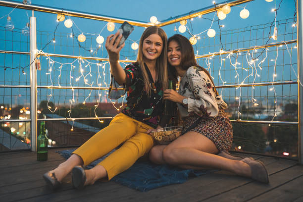 istock Female friends making a selfie at party 1067326014