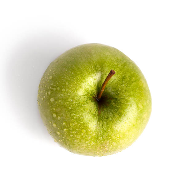 Fresh green apple in water drops on white background isolated close up macro top view