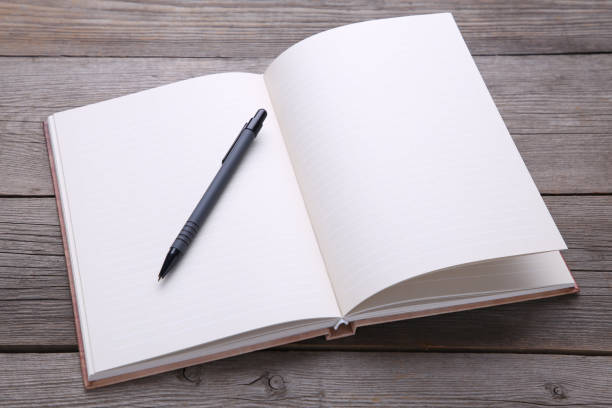 istock Notebook and pen on grey wood background 1067334548