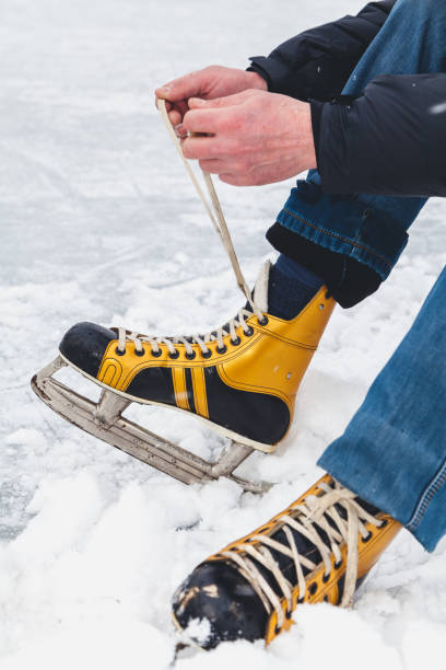 istock man ties up  shoelace on shoe boot 1067334854