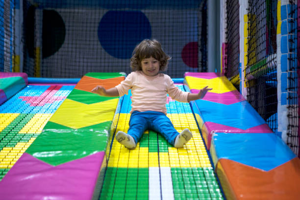 istock Smiling little Boy climbing and sliding on playground 1067337022