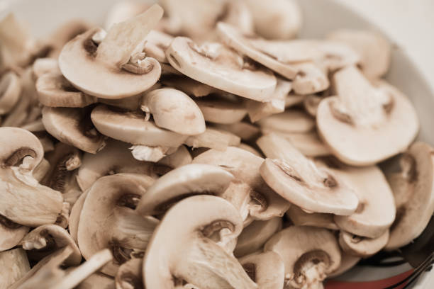 istock White mushrooms cut in thin slices 1067338130