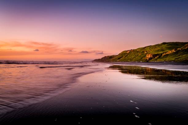 Sunset over Karioitahi beach black sand Waiuku Sunset over Karioitahi beach black sand Waiuku central vietnam stock pictures, royalty-free photos & images