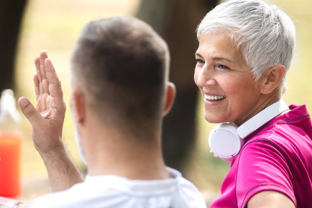 istock Senior couple taking a break after exercising in a park 1067342426