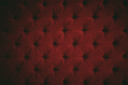 Dark red velvet pillow with buttons