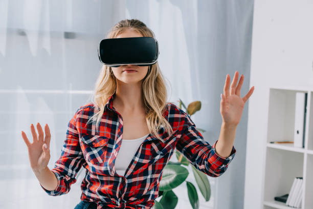 istock young woman in virtual reality headset gesturing in room 1067343504