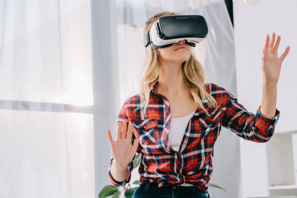 istock young woman in virtual reality headset gesturing in room 1067343554