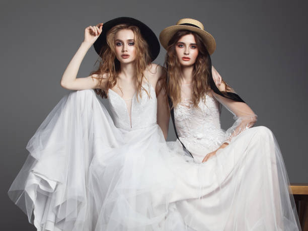 istock Beautiful brides in wedding dresses and hats 1067349014