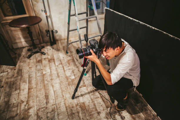 Professional photograher taking photos in his studio