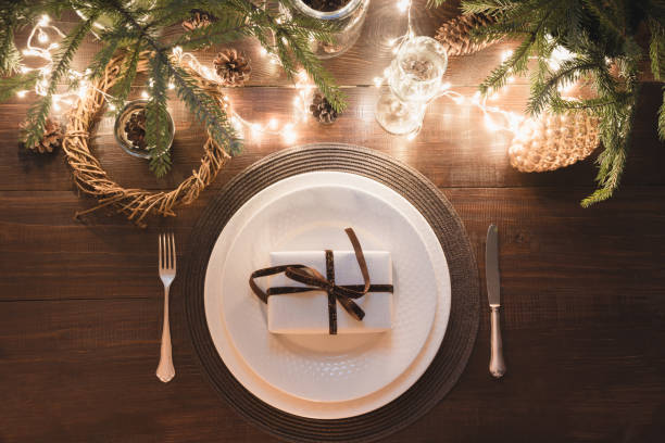 istock Christmas table setting with silverware, garland and dark decor. Top view. Xmas Party. Magic night. 1067351774