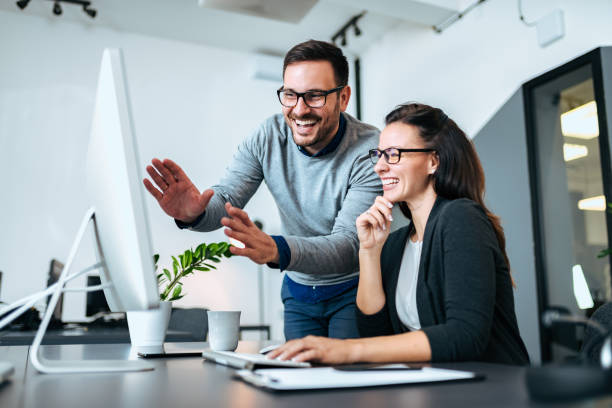 istock Teawork and success concept. Two business people smiling and looking at computer screen. 1067351796