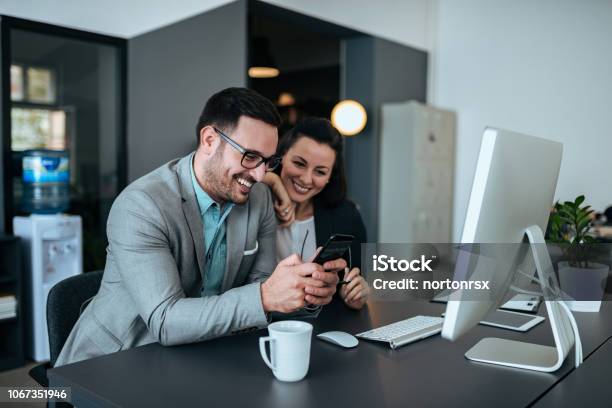 Young Happy Couple Working Together In The Office Stock Photo - Download Image Now - Couple - Relationship, Working, Adult