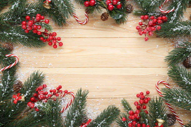 istock Christmas fir tree branches with candy canes on wooden table 1067352298