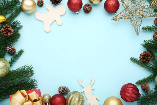 istock Christmas decorations with fir tree branches and cones on blue background 1067352370