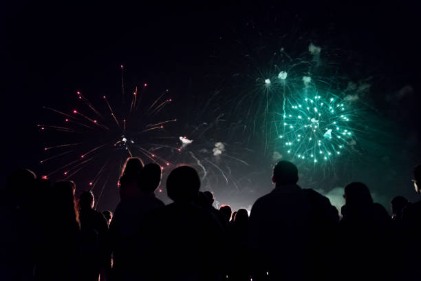 istock Crowd watching fireworks and celebrating new year eve 1067353720