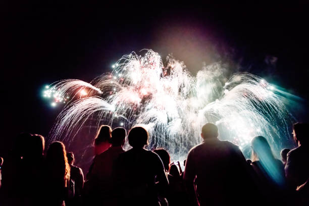 istock Crowd watching fireworks and celebrating new year eve 1067353746