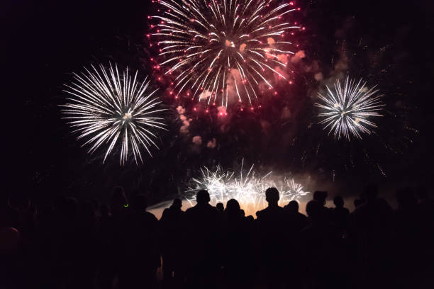 istock Crowd watching fireworks and celebrating new year eve 1067353920