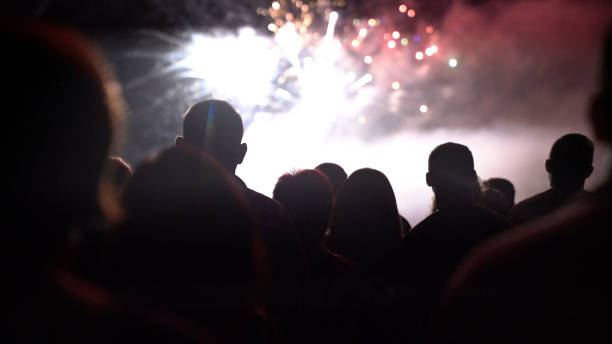 istock New year concept - cheering crowd and fireworks 1067354072