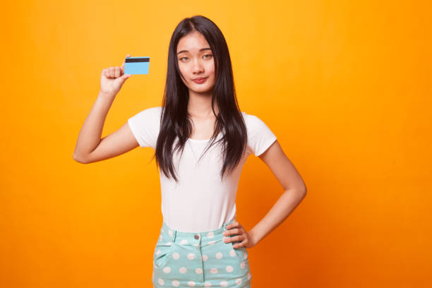 istock Young Asian woman with a blank card. 1067354184