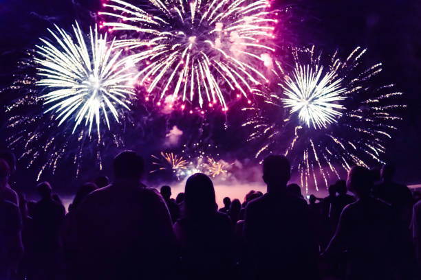 crowd watching fireworks and celebrating new year eve - pyrotechnics imagens e fotografias de stock