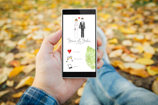 istock man in the park reiving mobile wedding invitation 1067355058