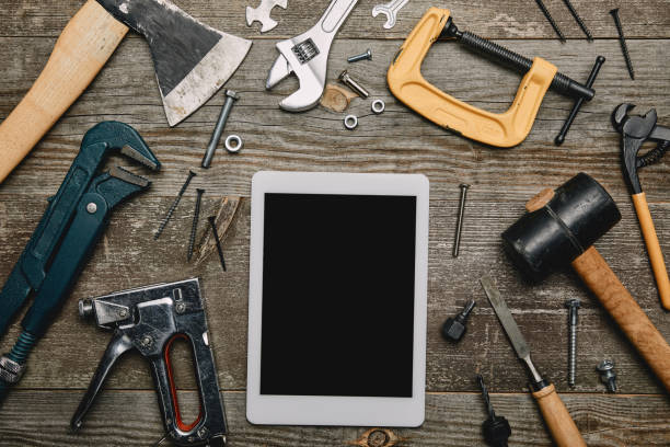 istock Flat lay with digital tablet and set of carpentry tools on wooden background 1067357730