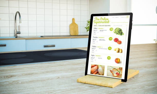 istock tablet pc with  online supermarket screen on cooking island at the kitchen 1067358570