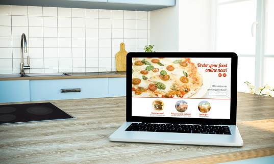 laptop online food order website at the kitchen 3d rendering