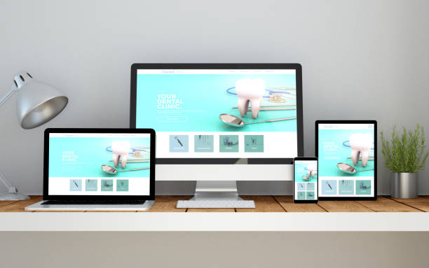 istock workplace with dental clinic online responsive website on devices 1067359372