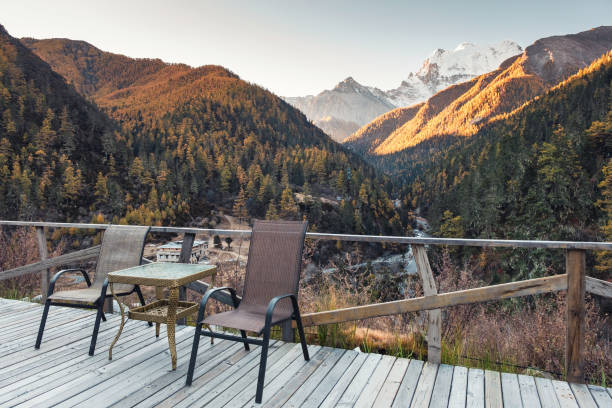 istock Chairs with table on wooden balcony with valley in autumn at evening 1067361268