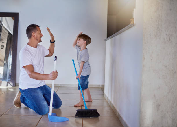 Good job buddy! Shot of a father and his little son high fiving each other while sweeping the floor at home sweeping photos stock pictures, royalty-free photos & images