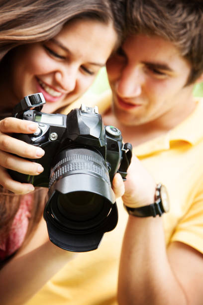istock young couple looking at photos taken on camera 1067362376