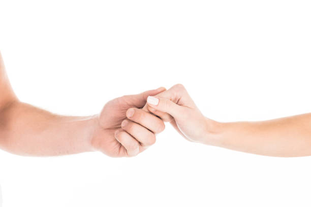 istock Partial view of people tenderly holding hands isolated on white 1067366608