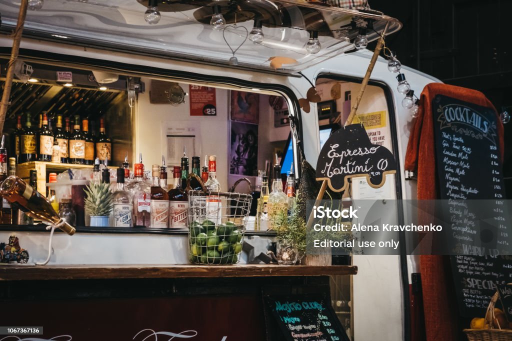 Bar and drinks truck stand in Mercato Metropolitano, London, UK. London, UK - November 2, 2018: Bar and drinks truck stand in Mercato Metropolitano, the first sustainable community market in London focused on revitalising the area and protecting environment. Bar - Drink Establishment Stock Photo