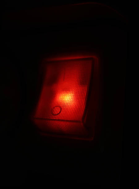 istock Abstract on off button, red light switcher in the darkness. 1067367346