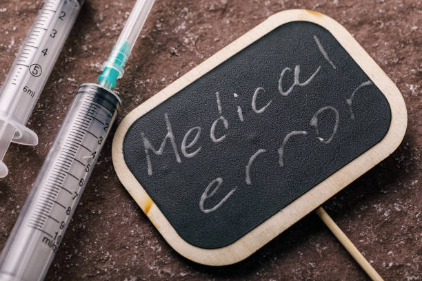 istock Empty syringes on the table and a sign that says medical error 1067370376