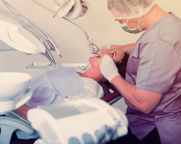 istock dentist professional filling teeth 1067370436