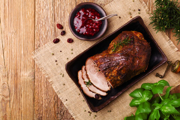 istock Roast pork with cranberry dip, basil, coriander and rosemary. 1067374676