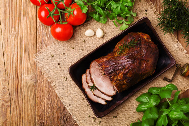 istock Roast pork with herbs and vegetables. 1067375700