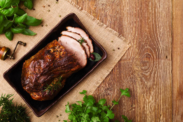 istock Roast pork with herbs and vegetables. 1067375710