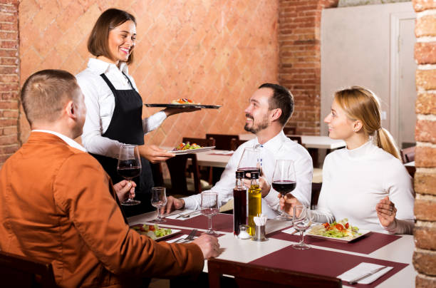 istock Waitress placing order in front of guests 1067379914
