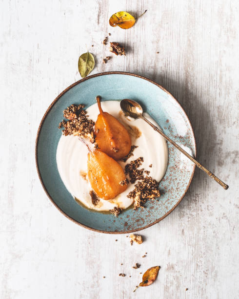 Roasted Pears with Honey, Quinoa Soufflé, Nuts and Mascarpone Cream for Dessert Roasted Pears with Honey, Puffed Quinoa, Nuts and Mascarpone Cream for Dessert pear dessert stock pictures, royalty-free photos & images