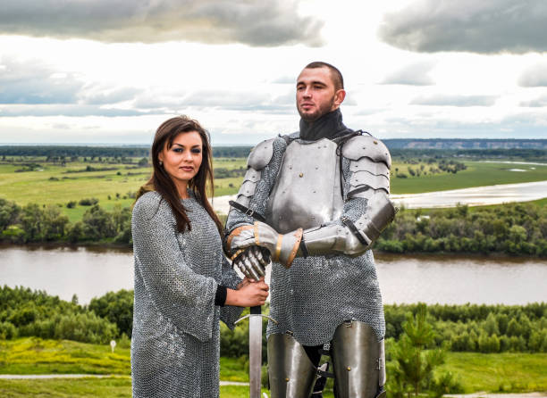 istock Knight with his lady in armor and chain mail. 1067380376