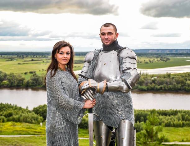 istock Knight with his lady in armor and chain mail. 1067380382
